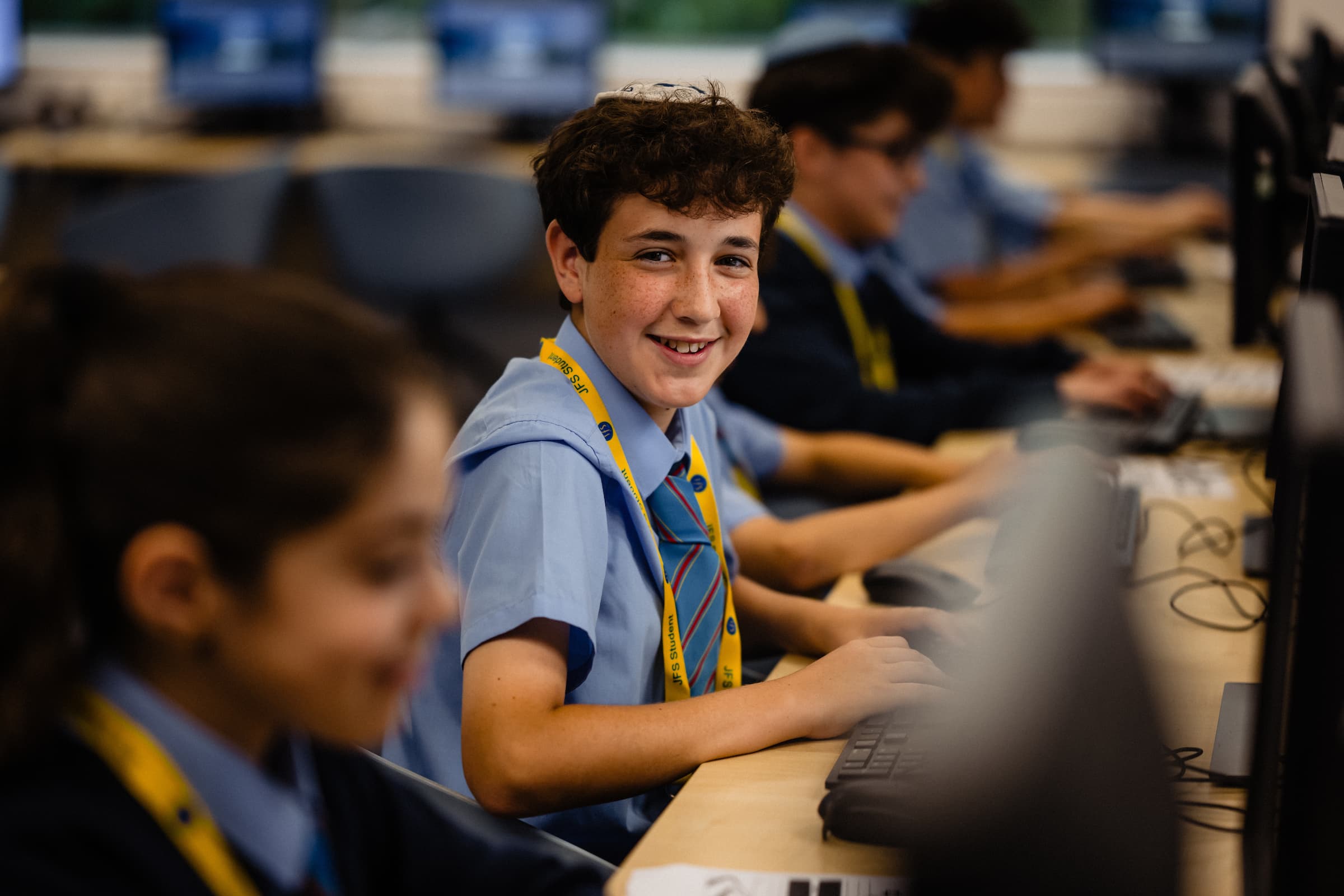 JFS student smiling in a computing lesson